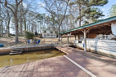Tucked along the water's edge, this charming rustic cottage is - photo 38