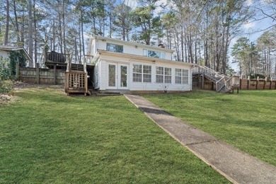 Tucked along the water's edge, this charming rustic cottage is - photo 39