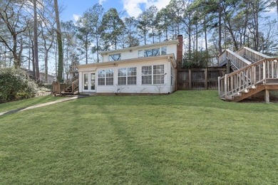 Tucked along the water's edge, this charming rustic cottage is - photo 40