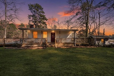 Tucked along the water's edge, this charming rustic cottage is - photo 42