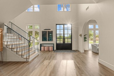 Nestled on a sprawling one-acre lot within the prestigious gated - photo 4