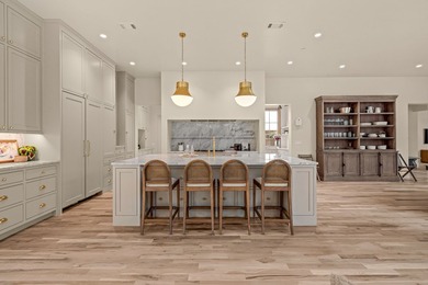 Nestled on a sprawling one-acre lot within the prestigious gated - photo 7