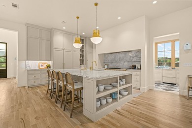 Nestled on a sprawling one-acre lot within the prestigious gated - photo 8