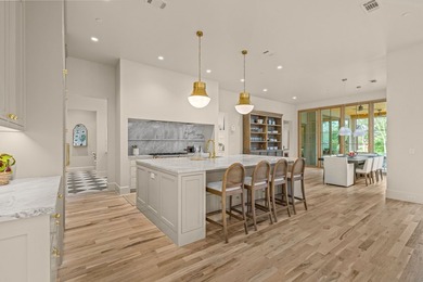 Nestled on a sprawling one-acre lot within the prestigious gated - photo 9