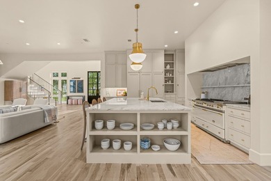 Nestled on a sprawling one-acre lot within the prestigious gated - photo 10