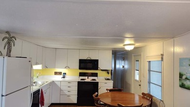 This charming 2-bedroom, 1.5-bath mobile home offers cozy - photo 2
