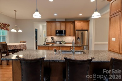 Peaceful Luxury awaits on a 1.4-acre lot in the gated community