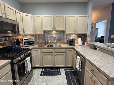 Move right into this bright 3rd-floor end-unit condo in the