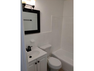 This solid concrete block multi-family property features two - photo 8