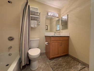 This fully furnished ground floor condo has tile floor and - photo 12