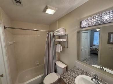 This fully furnished ground floor condo has tile floor and - photo 13