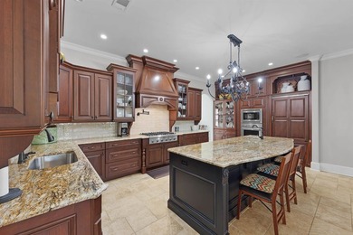 This elegant executive brick home offers luxury living and