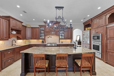 This elegant executive brick home offers luxury living and