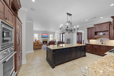 This elegant executive brick home offers luxury living and