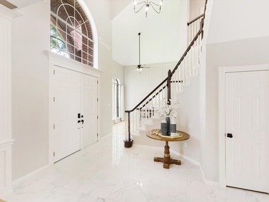 Grand marble tile entry and soaring ceilings set the tone in - photo 33