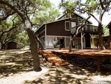 This beautifully presented lakehouse blends rustic elegance with - Lake Home For Sale in Lakehills, Texas