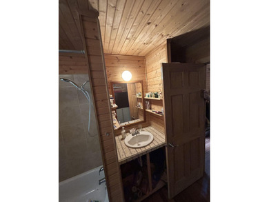 Escape to the serenity of the mountains with this charming cabin - photo 13