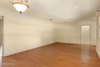 Underneath the branches of a mature live oak tree sits this