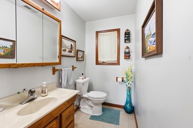 This charming two-story home sits right on the water's edge of - photo 12