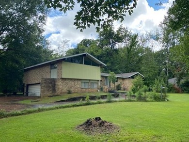 This brick home with 5 bedrooms and 3.5 baths with a double - photo 1
