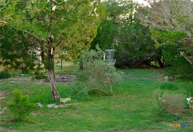 Nestled on a half-acre wooded lot in Rocky Creek Ranch, this - photo 14