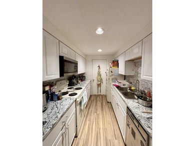Enjoy the ease of low-maintenance living in the desirable - photo 3