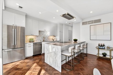 Originally configured as a three-bedroom, three-bath plan, this