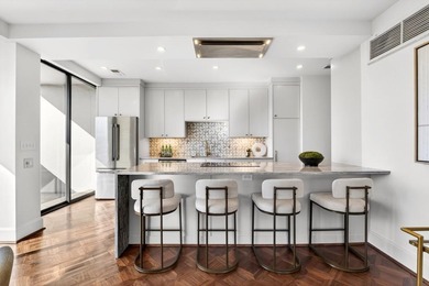 Originally configured as a three-bedroom, three-bath plan, this