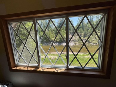 Nestled along the beautiful Rifle River, this charming - photo 16