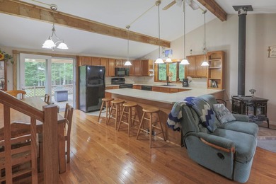 Nestled in the woods on beautifully landscaped grounds, this - photo 3