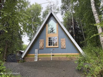 A-Frame cabin tucked into the birches between two good fishing
