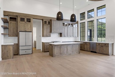 This custom home in Teton Reserve offers a unique plan with - photo 12