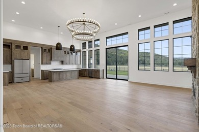 This custom home in Teton Reserve offers a unique plan with - photo 13