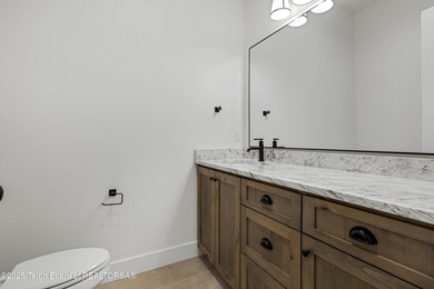 This custom home in Teton Reserve offers a unique plan with - photo 28