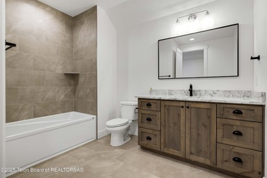 This custom home in Teton Reserve offers a unique plan with - photo 32