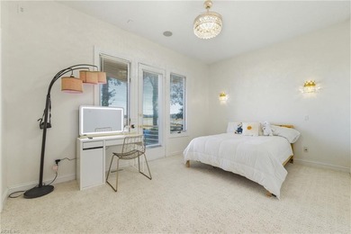 Welcome to this exquisite Spanish-style waterfront estate which