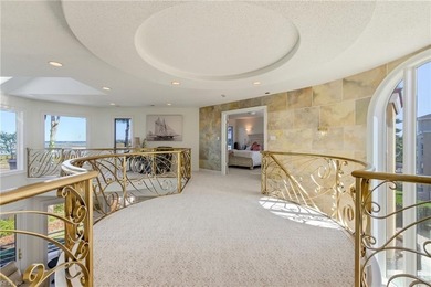 Welcome to this exquisite Spanish-style waterfront estate which