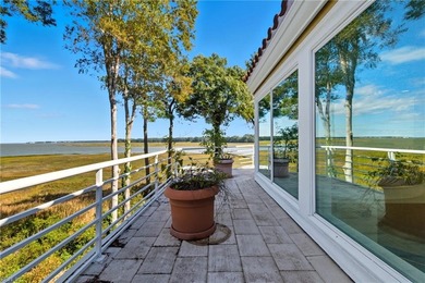 Welcome to this exquisite Spanish-style waterfront estate which