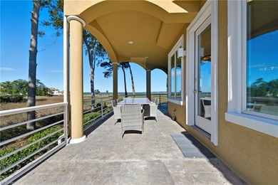 Welcome to this exquisite Spanish-style waterfront estate which