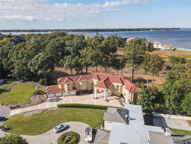 Welcome to this exquisite Spanish-style waterfront estate which