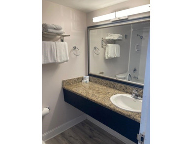 Carpet and wood floors; king bed and large sofa. Updated unit - photo 11