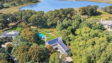Set on the tranquil shores of Genet Creek, this modern - photo 2