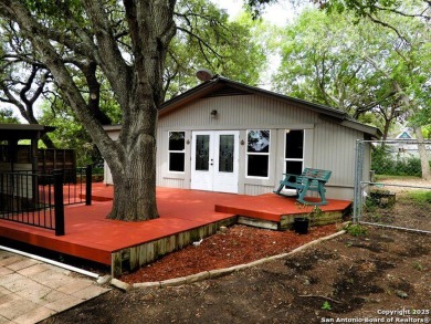 This charming home is beautifully nestled beneath large, shady - Lake Home For Sale in Lakehills, Texas