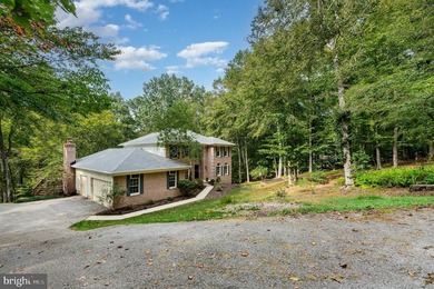 Tucked away on five private acres with a stream that feeds into - photo 3