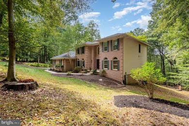 Tucked away on five private acres with a stream that feeds into - photo 4