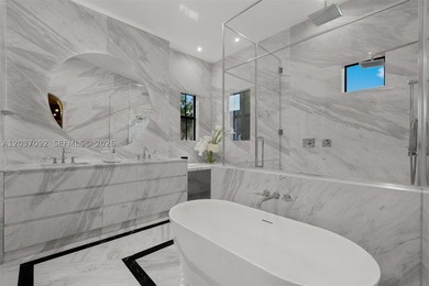 Completely renovated in 2025, this gated three-story residence - photo 14
