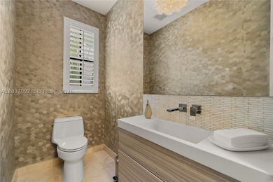 Completely renovated in 2025, this gated three-story residence - photo 24