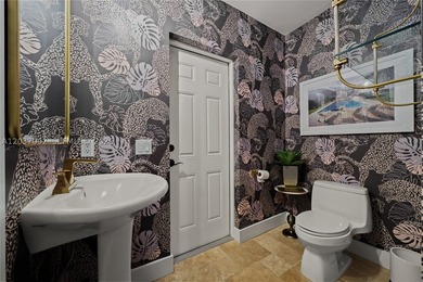 Completely renovated in 2025, this gated three-story residence - photo 32