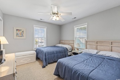 This spacious five-bedroom, four-bathroom raised beach home is