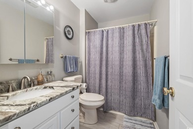 This spacious five-bedroom, four-bathroom raised beach home is